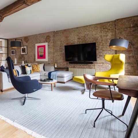 Relax on the mid-century-style yellow armchair after a busy day in London