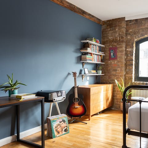 Put some vinyl on the retro record player in the second bedroom