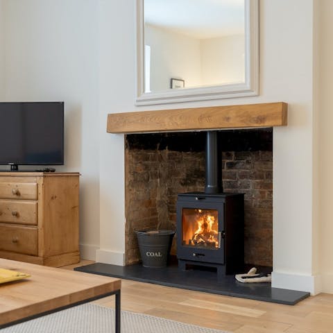 Warm up by the wood-burning stove after a walk through the countryside