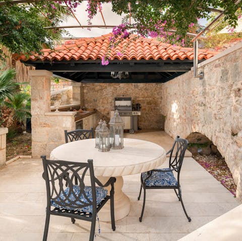 Dig into a barbecue dinner with cevapcici, as you discuss the day with your loved ones