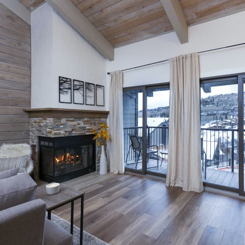 Cosy up by the fire with a view of the snow-capped mountains
