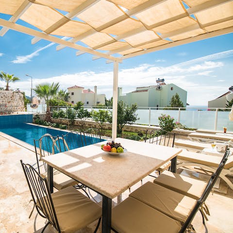 Dine poolside on the covered terrace