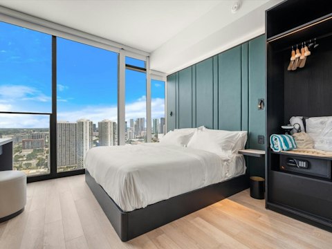 Wake up to the city views through floor-to-ceiling windows