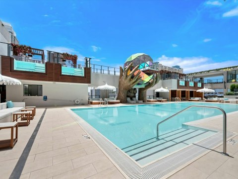 Cool off in the communal pool beneath the Miami sky