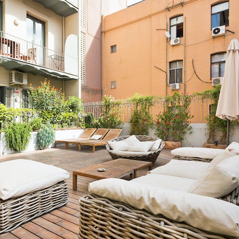 Snuggle up on the luxe cushioned seats on the terrace with a glass of sangria