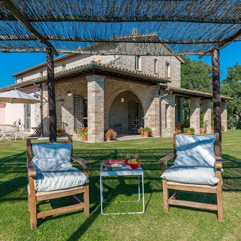 Take shade under the pergola as you start your holiday read