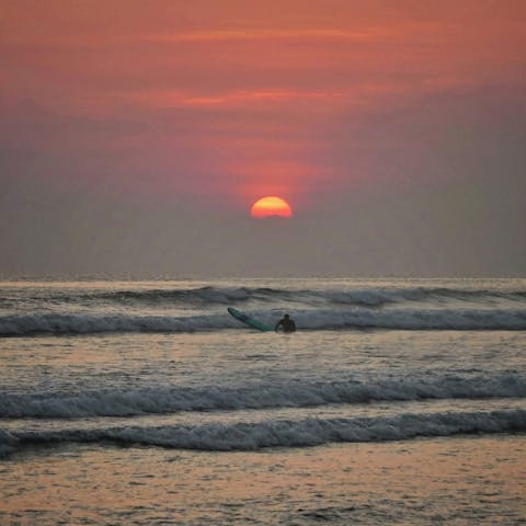 Go surfing at sunset on Seminyak Beach, only 500 metres away
