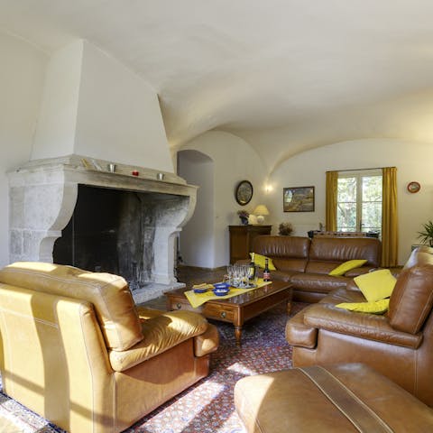 Cosy up by the original, stone fireplace in the rustic lounge