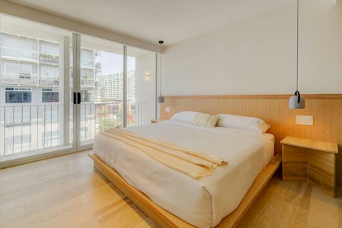 Wake to city views from a calm, light-washed bedroom