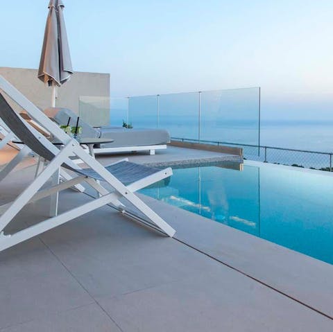 Spend your days dipping in and out of the private pool overlooking the blue Ionian Sea
