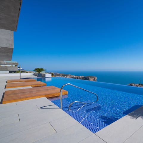 Take a refreshing dip in the pool while soaking up infinite blue views