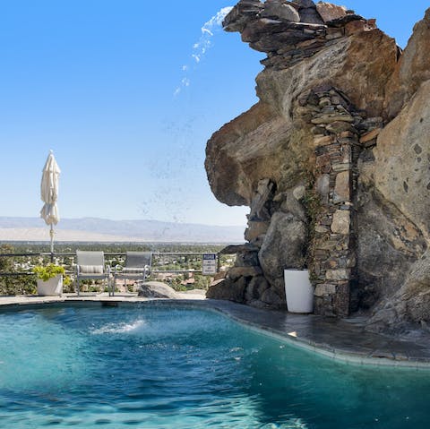 Cool off beneath the pool's waterfall