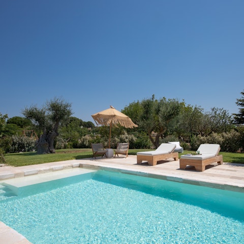 Doze off on a lounger after a leisurely swim in the pool