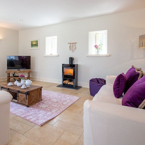 Cosy up by the wood burner after a busy day of exploring