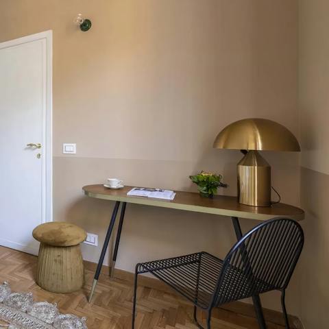 Catch up on work at the bedroom's chic desk space