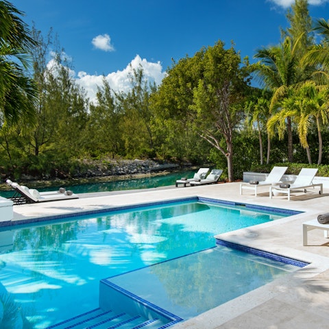Swim in the outdoor private pool or enjoy a cocktail at the poolside seating area