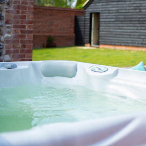 Relax in the steaming hot tub with a glass of fizz