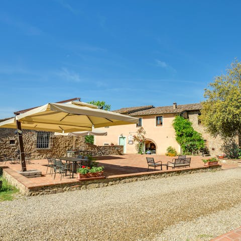 Pour yourself a glass of wine to enjoy in the shade of the patio umbrellas