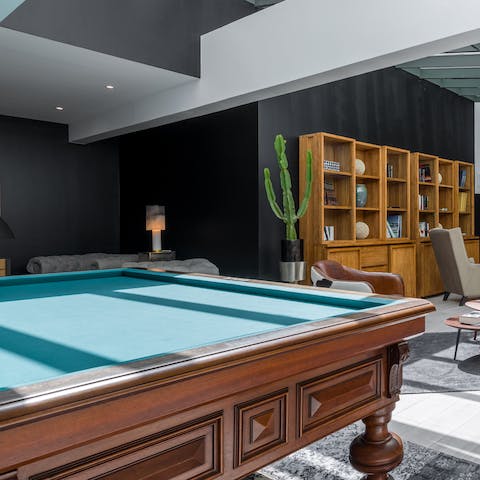 Play a game of pool in the building's communal lounge area
