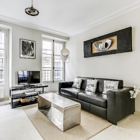 Kick back in the bright living room after a day of Paris sightseeing, a glass of French wine in hand