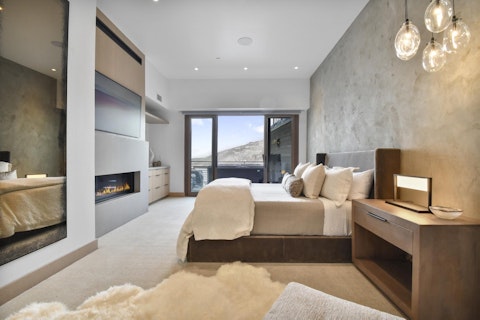 Sleep beside a flickering fireplace with peaks framing the view