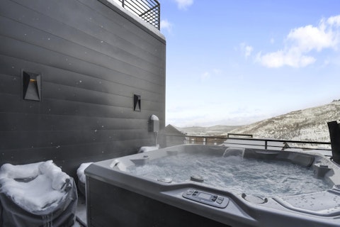 Soak in steaming water while mountain ridges stretch across the horizon