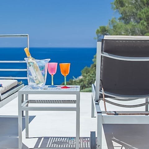 Enjoy happy hour cocktails in front of the majestic sea vistas