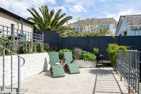 Unwind on the sun loungers in this sheltered private garden