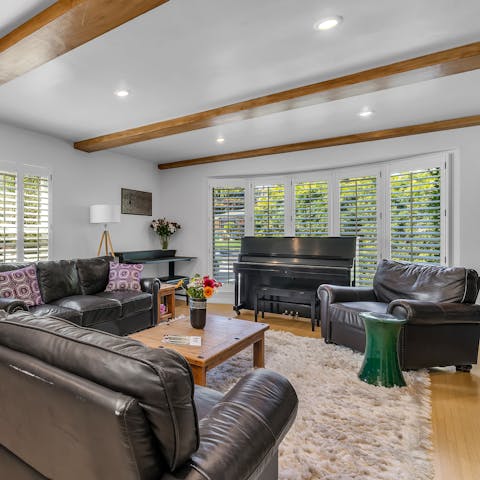 Relax in the comfort of the living room featuring a beautiful piano