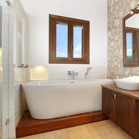 Treat yourself to an luxurious bubble bath in the sleek bathroom