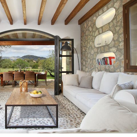 Get cosy and relax in the elegant living room which opens directly onto the garden