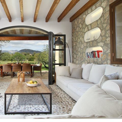 Get cosy and relax in the elegant living room which opens directly onto the garden