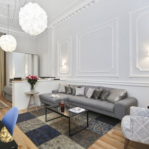 Kick back with a glass of wine on the elegant sofa beneath the corniced ceilings