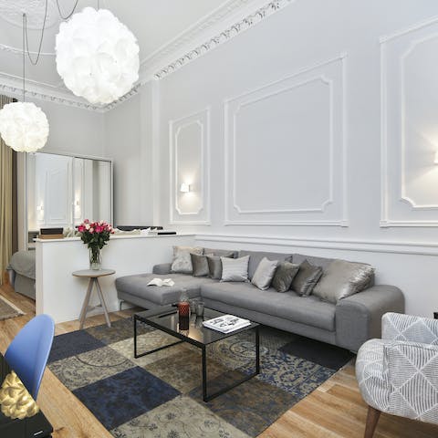 Kick back with a glass of wine on the elegant sofa beneath the corniced ceilings