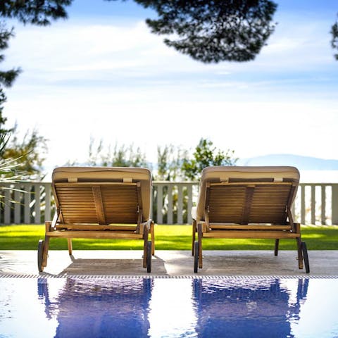 Paddle about in the villa's swimming pool and dry off on a lounger overlooking the sea