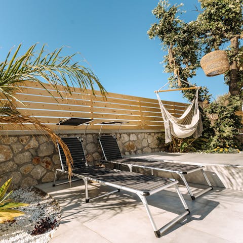 Lounge on the sun beds by the pool for a sun-kissed glow