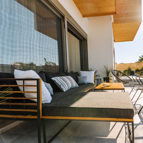 Snnugle up on the comfy L-shaped cushions with a glass of something cold