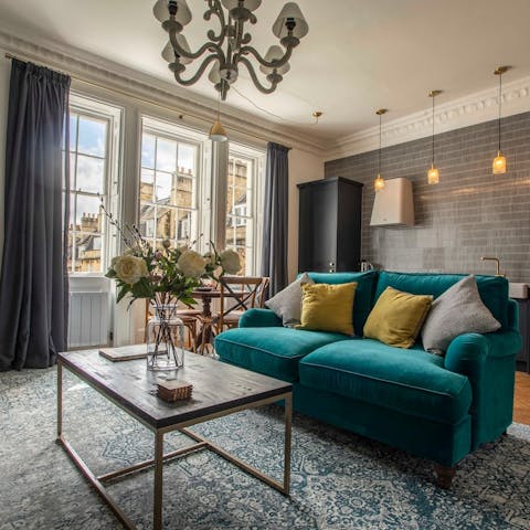 Relax in the bright open-plan living space with garden views