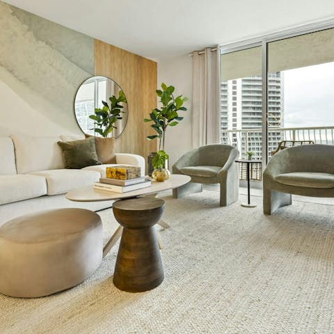 Flit between the stylish living room and the small balcony