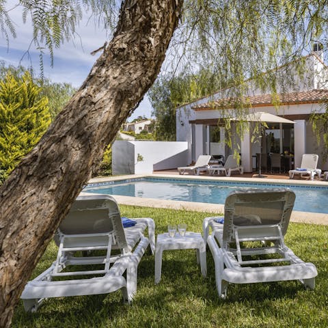 Relax in the sun or shade on one of the poolside loungers