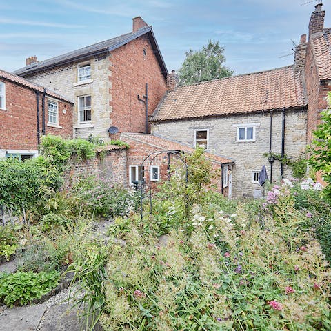 Explore the private garden, complete with an array of flowers and greenery