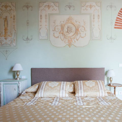 Fall asleep underneath handpainted frescoes in the sumptuous bedroom