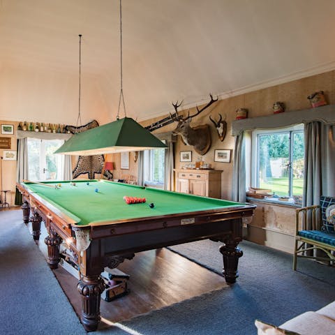 Play billiards while the kids run riot in their very own playroom