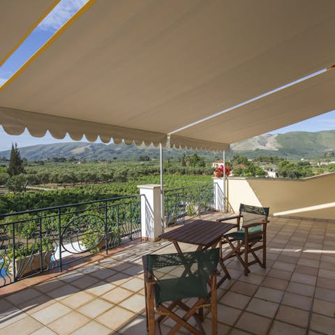 Admire the rolling green countryside from the covered terrace