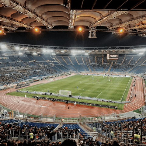 Walk for half an hour to the Stadio Olimpico, home of Lazio and Roma