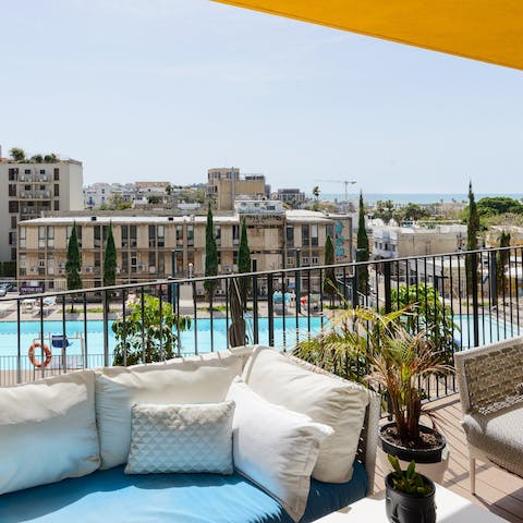 Spend sunny afternoons on the terrace where the shared pool downstairs invites cool dips