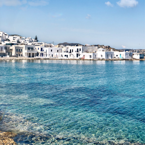 Explore the stunning island of Paros, with dreamy white architecture next to crystal-clear waters