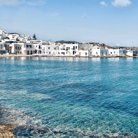 Explore the stunning island of Paros, with dreamy white architecture next to crystal-clear waters