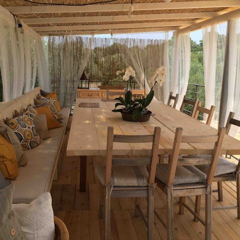 Savour fresh Sardinian cuisine on the shaded terrace