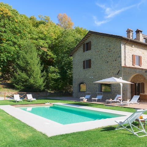 Soak up the sun from a daybed or cool off with a dip in the glistening pool